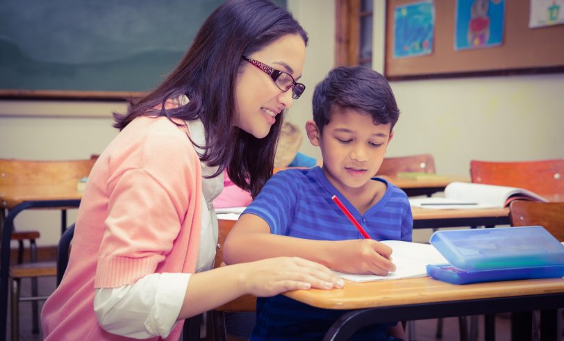 Teacher helping student