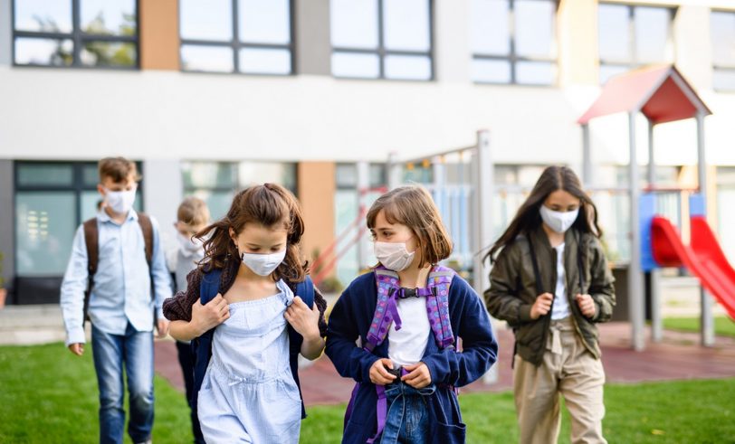 Students wearing masks leaving school